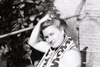 a black and white photo of a woman wearing a scarf